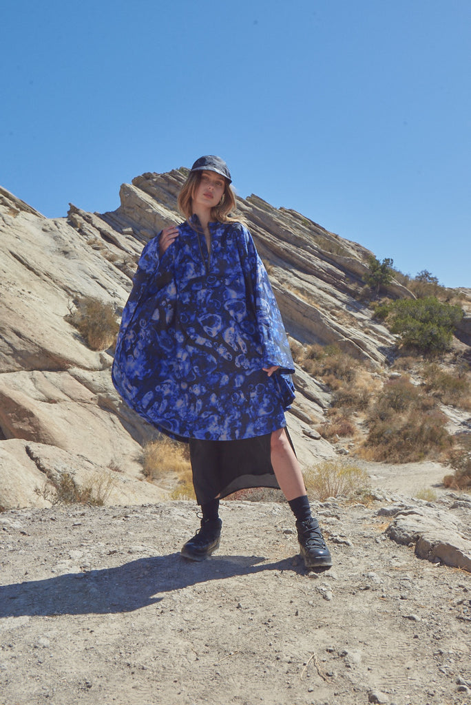Woman wearing black raincoat man wearing blue pullover anorak by Ponch ann Leif Podhajsky